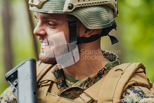 Image of A modern warfare soldier on war duty in dense and dangerous forest areas. Dangerous military rescue operations