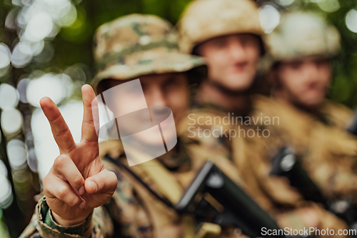 Image of Soldier fighters standing together with guns. Group portrait of US army elite members, private military company servicemen, anti terrorist squad