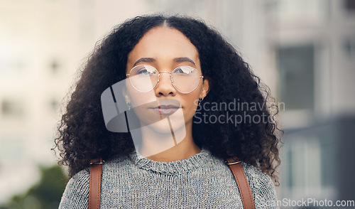 Image of Serious, confident and portrait of a woman in the city with glasses for eye care or vision. Beautiful, young and headshot of young female person from Mexico exploring an urban town street for travel.