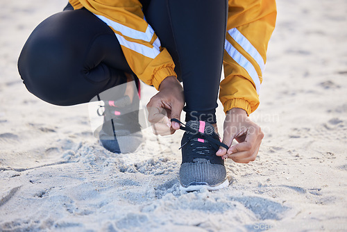 Image of Beach, closeup and woman tie shoes for an outdoor run for fitness, health and wellness by seaside. Sports, athlete and zoom of female runner tying laces for a cardio workout or exercise by the ocean.