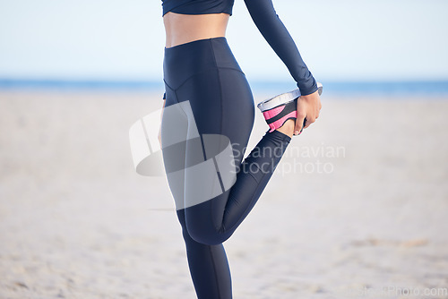 Image of Woman, fitness and stretching legs for exercise, training or outdoor running on the beach. Female person, athlete or runner in preparation, body or feet warm up getting ready for cardio workout