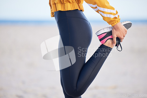 Image of Woman, fitness and stretching legs for workout, training or outdoor running on the beach. Female person, athlete or runner in preparation, body or feet warm up getting ready for cardio exercise