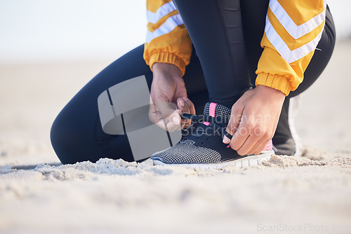 Image of Beach, closeup and woman tie laces for an outdoor run for fitness, health and wellness by seaside. Sports, athlete and zoom of female runner preparing for a cardio workout or exercise by the ocean.