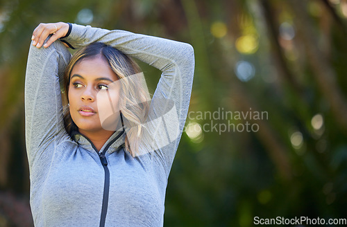 Image of Nature, fitness and young woman doing a warm up for an outdoor workout or training. Sports, happy and female athlete stretching her arms in a park for a running cardio exercise in a green garden.