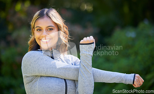 Image of Nature, sports and portrait of a woman stretching her arms for an outdoor workout or training. Fitness, happy and young female athlete doing a warm up exercise in a park for cardio running in garden.