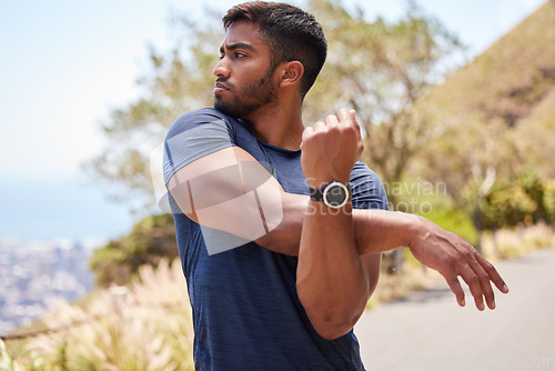 Image of Thinking, man or runner stretching arms for fitness training, wellness or exercise outdoors on road. Relax, muscle flexibility and healthy Indian male athlete in warm up to start running workout