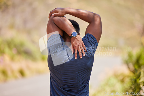 Image of Fitness, man or runner stretching arms for fitness training, wellness or cardio exercise outdoors on road. Relax, flexibility and back view of healthy male athlete in warm up to start running workout