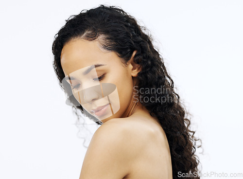 Image of Face, beauty and skin with a model black woman looking at her shoulder in studio on a white background. Portrait, skincare and sensual with an attractive young female admiring her smooth or soft body