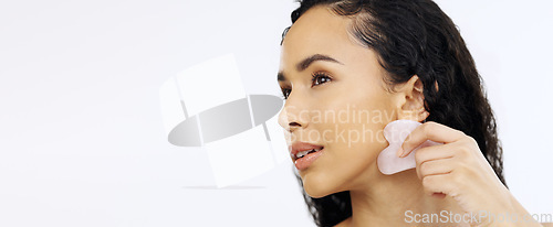 Image of Black woman, face and beauty with gua sha for skincare, facial and exfoliate isolated on white background. Dermatology, skin glow and cosmetic tools, female model satisfied with hand and mockup