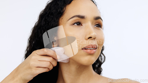 Image of Black woman, face and beauty with facial gua sha, skincare routine and exfoliate isolated on white background. Dermatology, skin glow and cosmetic tools, female model satisfied with hand and mockup