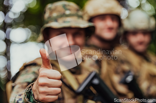 Image of Soldier fighters standing together with guns. Group portrait of US army elite members, private military company servicemen, anti terrorist squad