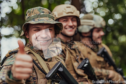 Image of Soldier fighters standing together with guns. Group portrait of US army elite members, private military company servicemen, anti terrorist squad