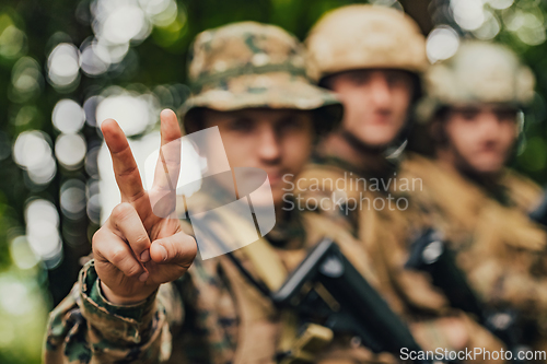 Image of Soldier fighters standing together with guns. Group portrait of US army elite members, private military company servicemen, anti terrorist squad