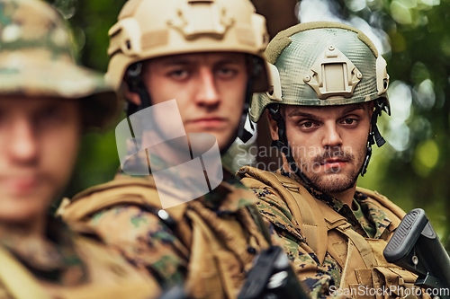 Image of Soldier fighters standing together with guns. Group portrait of US army elite members, private military company servicemen, anti terrorist squad