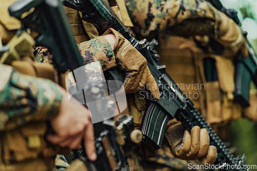 Image of Soldier fighters standing together with guns. Group portrait of US army elite members, private military company servicemen, anti terrorist squad