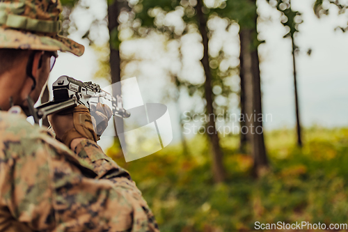 Image of A modern warfare soldier on war duty in dense and dangerous forest areas. Dangerous military rescue operations