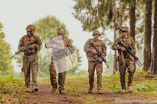 Image of Soldier fighters standing together with guns. Group portrait of US army elite members, private military company servicemen, anti terrorist squad