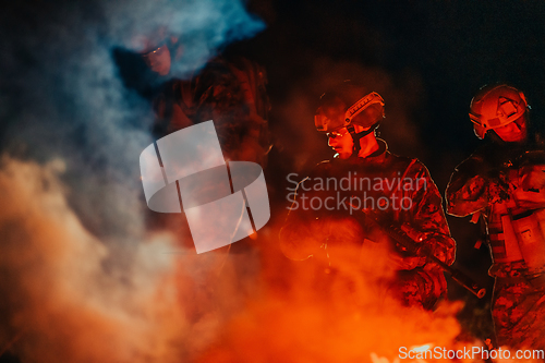 Image of Soldiers squad in action on night mission using laser sight beam lights military team concept