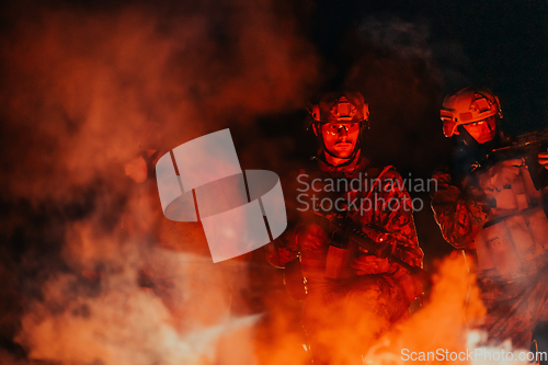 Image of Soldiers squad in action on night mission using laser sight beam lights military team concept