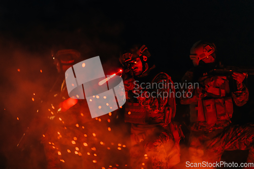 Image of Soldiers squad in action on night mission using laser sight beam lights military team concept