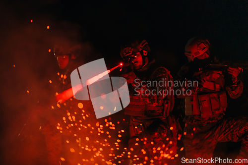 Image of Soldiers squad in action on night mission using laser sight beam lights military team concept