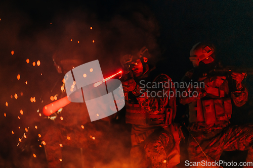 Image of Soldiers squad in action on night mission using laser sight beam lights military team concept