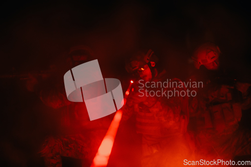 Image of Soldiers squad in action on night mission using laser sight beam lights military team concept