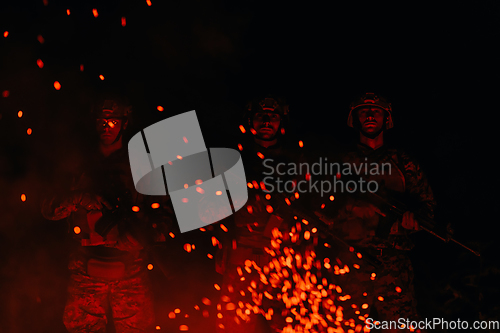 Image of Soldiers squad in action on night mission using laser sight beam lights military team concept