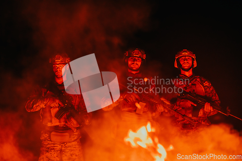 Image of Soldiers squad in action on night mission using laser sight beam lights military team concept