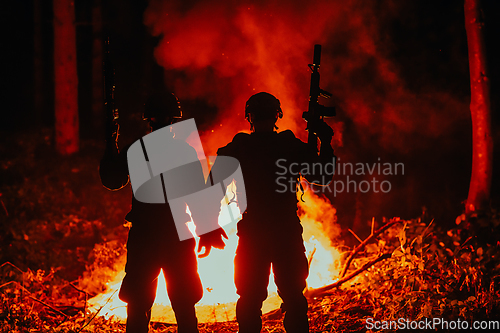 Image of Special marines military forces squad soldiers group portrait after finished mission complete fire in background