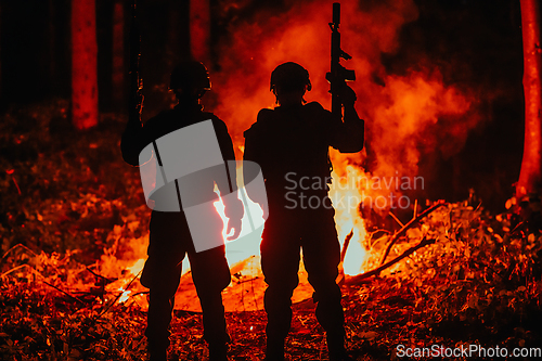 Image of Special marines military forces squad soldiers group portrait after finished mission complete fire in background