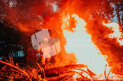 Image of firefighter hero in action danger jumping over fire flame to rescue and save