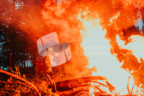 Image of firefighter hero in action danger jumping over fire flame to rescue and save