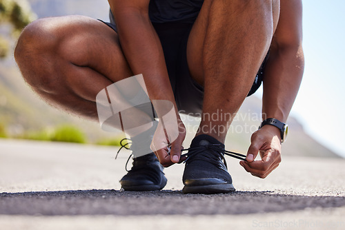 Image of Running, hands or person on road with shoes for fitness exercise, workout and marathon training. Closeup, tying lace or athlete runner ready to run, walk or jog with sneakers, trainers or footwear