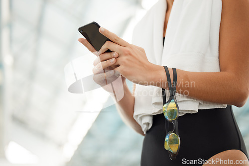 Image of Phone, hands and athlete typing at swimming pool for social media, networking and internet app. Technology, swim and woman with smartphone for website, online sport or training, workout and exercise