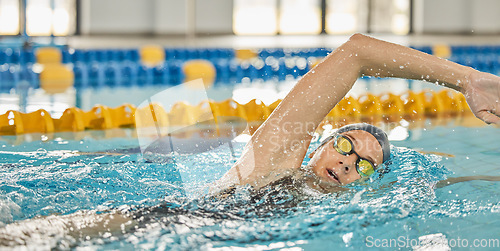 Image of Sports, water or girl training in swimming pool for a race competition, exercise or cardio workout. Female swimmer, wellness or healthy woman exercising with fitness speed in practice or race