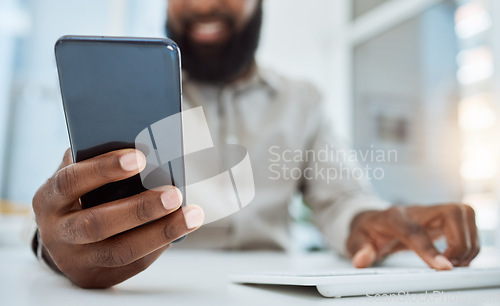 Image of Business man, hands and typing on smartphone at computer in office for social network, mobile website and digital contact. Closeup of worker reading news, notification and app on cellphone at pc desk