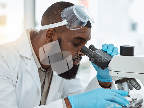 Image of Microscope, medical science and a man in a laboratory for research, study and analysis or focus. Face of a black person or scientist with a scope for innovation, biotechnology and future development