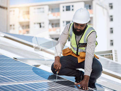 Image of African engineer man, screwdriver and solar panel on roof for maintenance, industry or thinking in city. Technician, builder and tools for photovoltaic tech, helmet and sustainable renewable energy