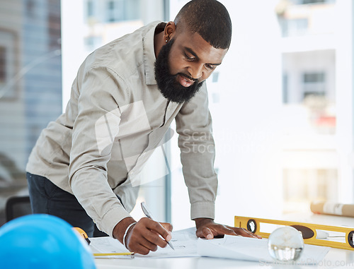 Image of Architect, blueprint and black man writing in office on paper, construction and project planning. Engineer, architecture and male manager with plan for property and renovation strategy with focus