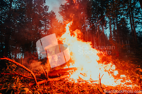 Image of firefighter hero in action danger jumping over fire flame to rescue and save