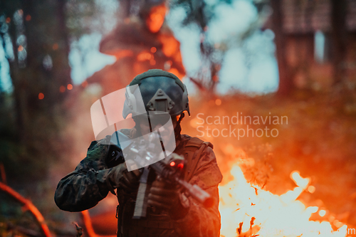 Image of A soldier fights in a warforest area surrounded by fire