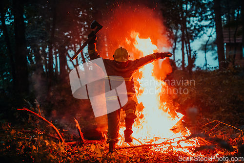 Image of firefighter hero in action danger jumping over fire flame to rescue and save