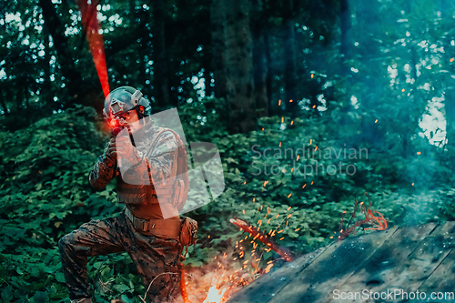 Image of A soldier fights in a warforest area surrounded by fire