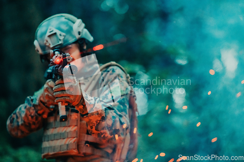 Image of A soldier fights in a warforest area surrounded by fire