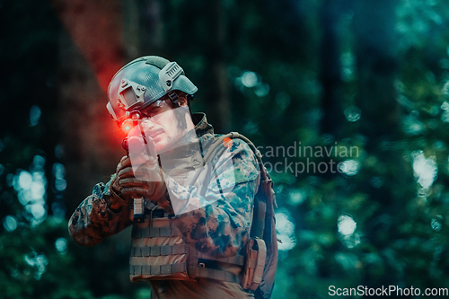 Image of A soldier fights in a warforest area surrounded by fire