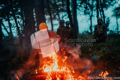 Image of firefighter hero in action danger jumping over fire flame to rescue and save