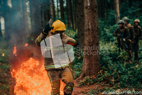 Image of firefighter hero in action danger jumping over fire flame to rescue and save