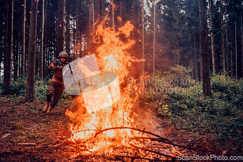 Image of Modern warfare soldiers surrounded by fire fight in dense and dangerous forest areas