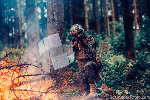 Image of A soldier fights in a warforest area surrounded by fire